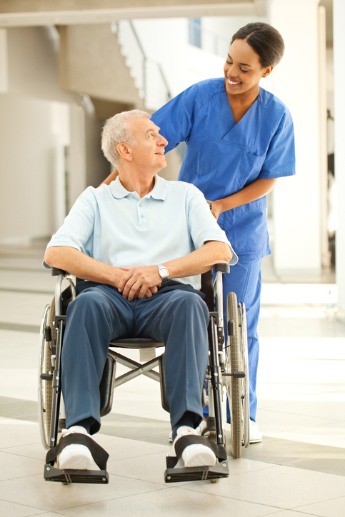 Nurse helping a patient in wheelchair